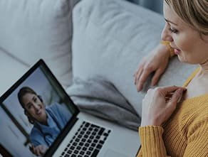 A woman having an online consultation with a clinician
